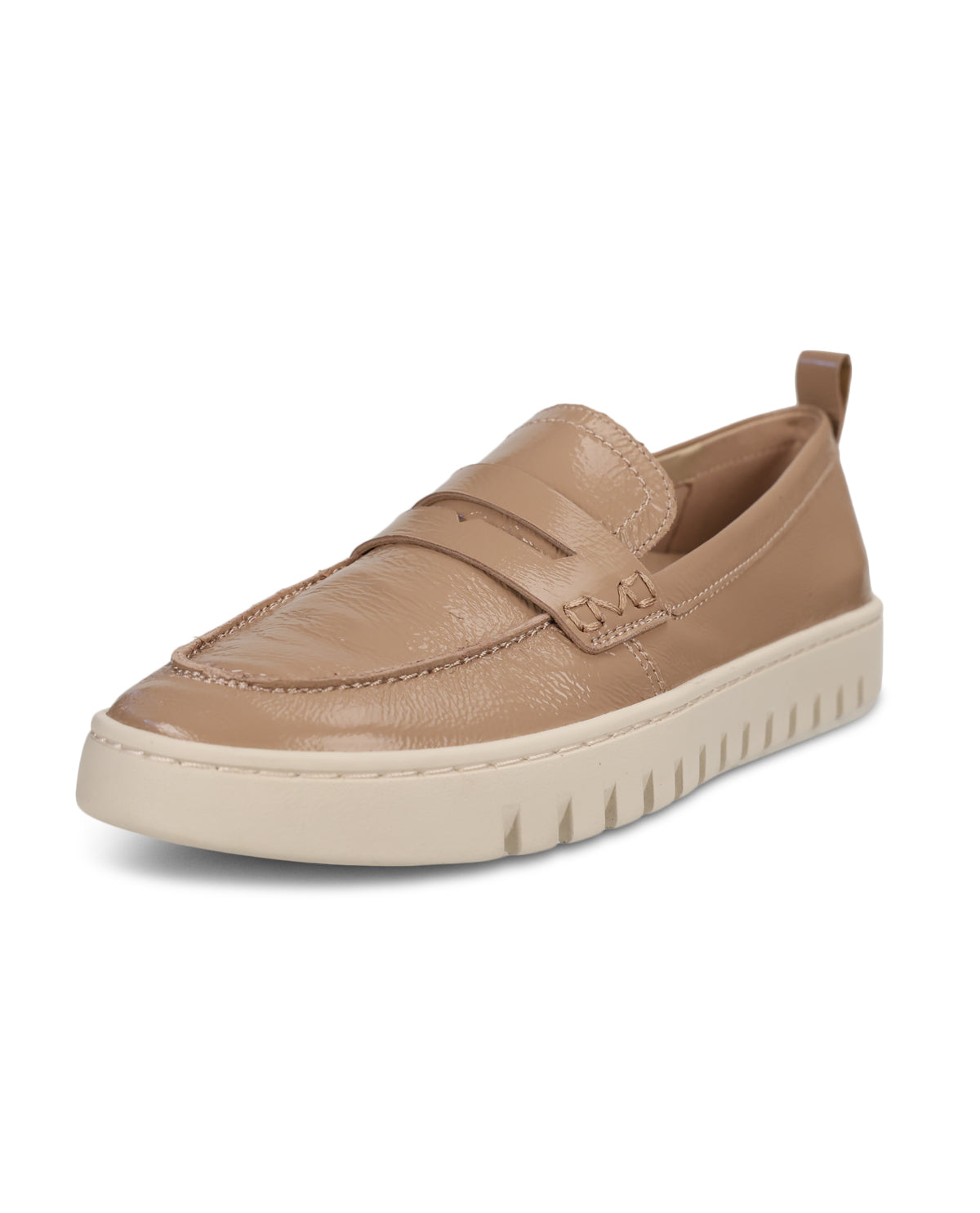 A single slip-on loafer in light tan leather with a textured toe cap and a thick, ridged cream platform sole, shown on a plain white background.