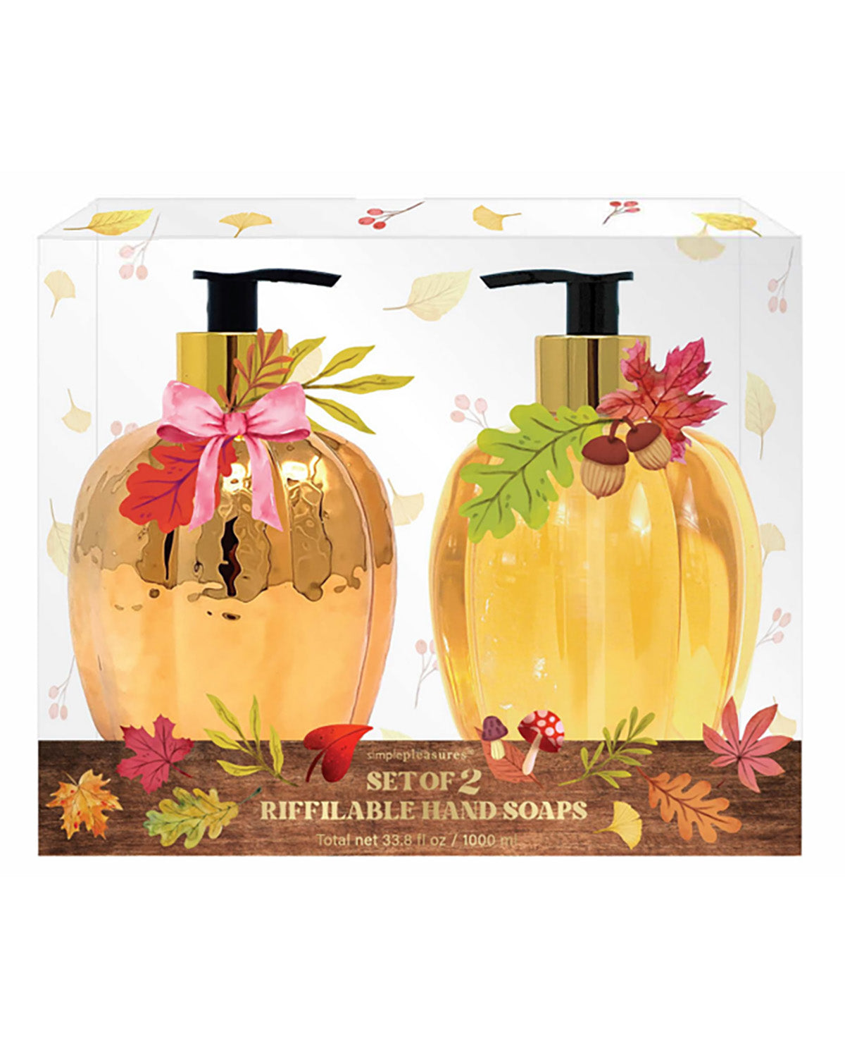 A boxed set of two refillable hand soaps shaped like metallic gold pumpkins, displayed in a clear-front package with autumn leaf and acorn decorations. The front label reads 'The Art of Living Set of 2 Refillable Hand Soaps'.