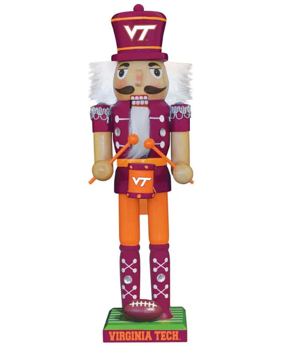 A Virginia Tech football-themed nutcracker figurine standing on a green base labeled 'VIRGINIA TECH'. The nutcracker wears a maroon and gold uniform with white hair, orange pants, and holds orange drumsticks, with a maroon football on its foot.