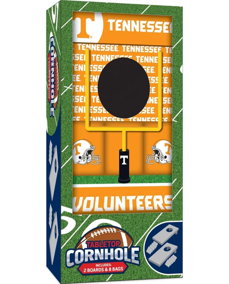 Tennessee Volunteers branded tabletop cornhole game in retail packaging, showing the box front with orange field graphics, white Tennessee 'T' helmets, and a visible black-and-yellow cornhole board inside.