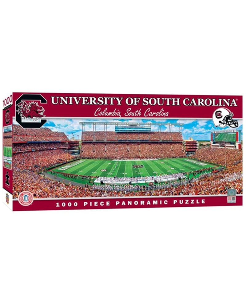 A 1000-piece panoramic jigsaw puzzle box for the University of South Carolina, featuring a vibrant graphic of a football stadium filled with fans on a green field.