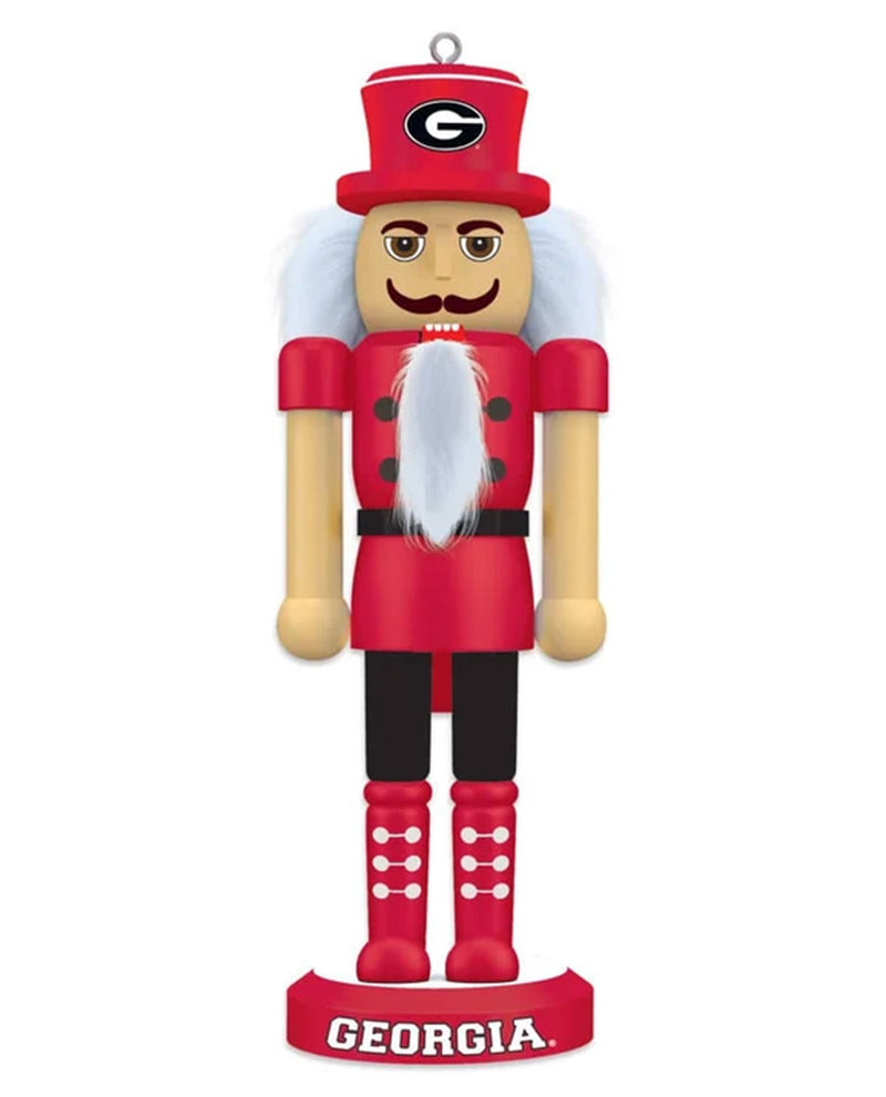 A Georgia Bulldogs nutcracker ornament standing on a red base labeled GEORGIA. The figure wears a red uniform and hat with black accents, a white beard, and a beige face and hands, photographed on a plain white background.