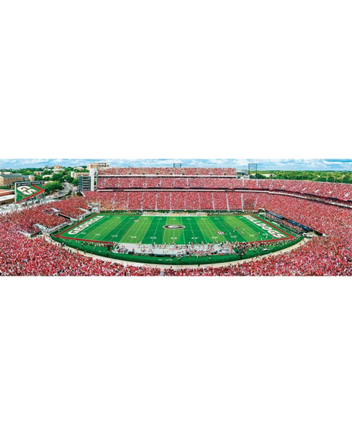 Aerial view of a large football stadium filled with red-clad spectators, with a green field and white yard lines in the center.