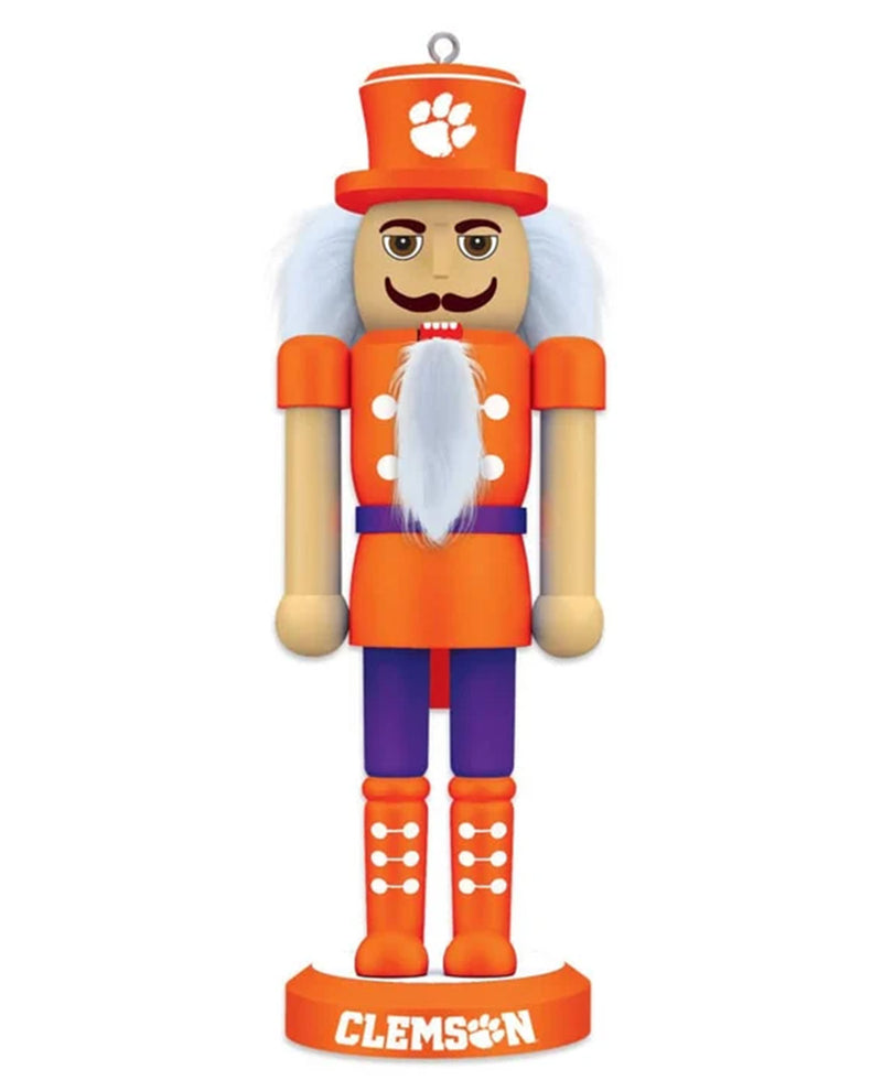 A Clemson Tigers themed wooden nutcracker figurine on a solid white background. The character features an orange and purple uniform, a white beard, and a matching orange top hat with the white Clemson paw print logo.