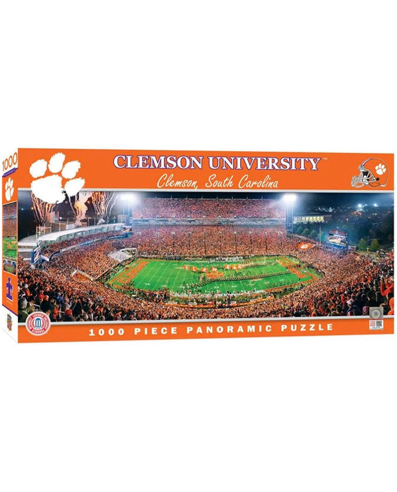 Clemson University 1000-piece panoramic jigsaw puzzle box, featuring an orange design with the Clemson paw print logo and a stadium scene filled with fans.