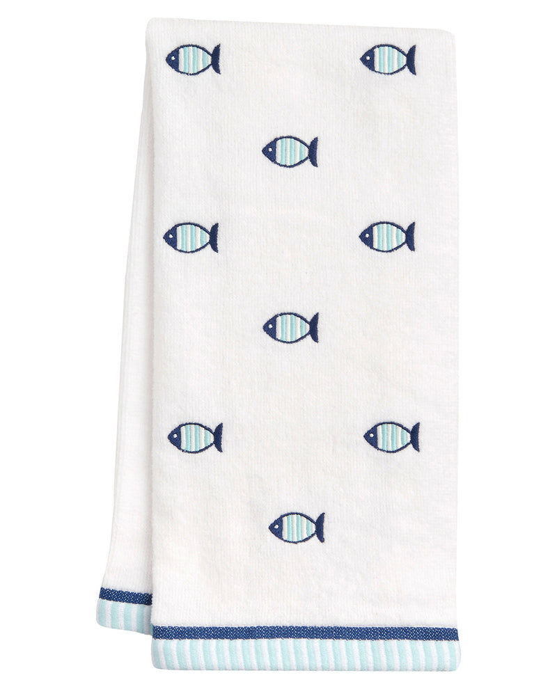 A white kitchen towel featuring a pattern of small blue and light blue striped fish, finished with a navy blue and light blue striped border at the bottom.
