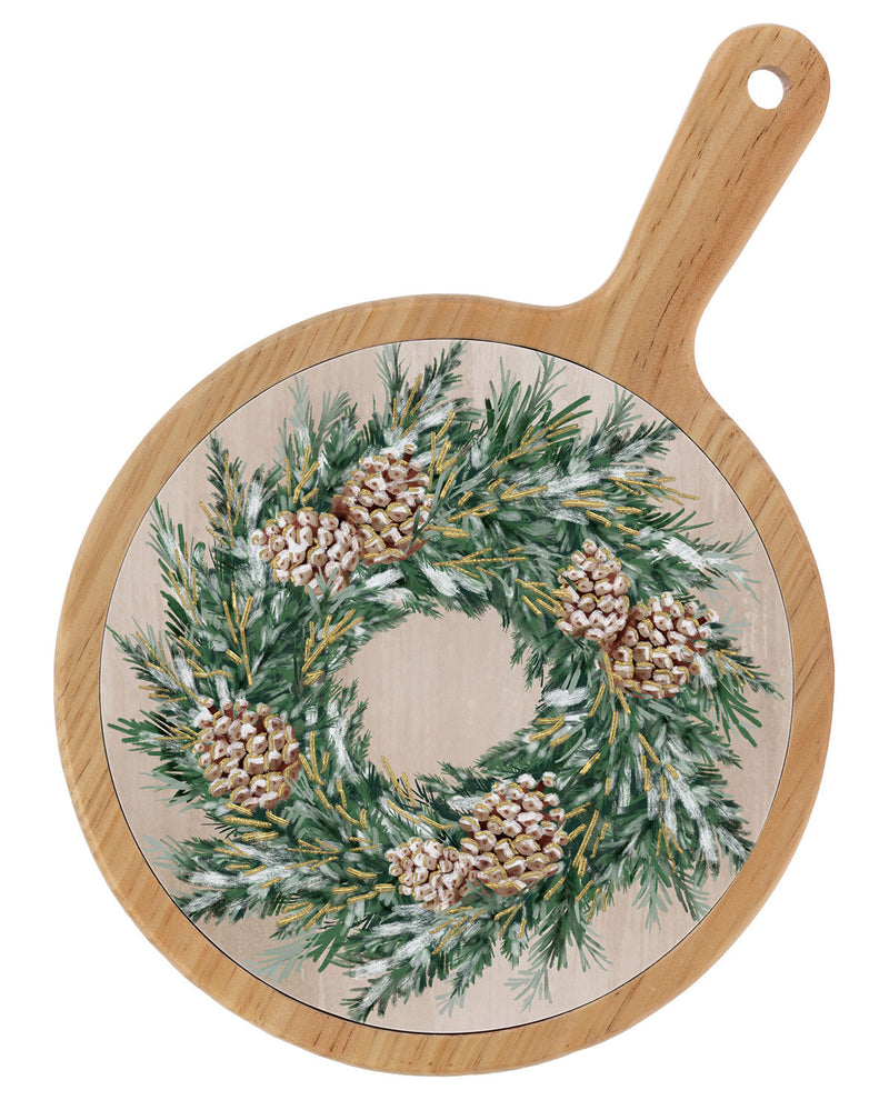 Round wooden serving board with a handle, featuring a printed festive wreath design with green pine branches, snow-dusted pinecones, and a light wood background.