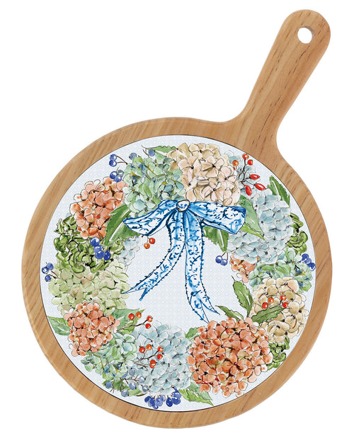 Round wooden serving board with a handle, featuring a printed floral wreath design with hydrangeas and a blue bow on a white background.