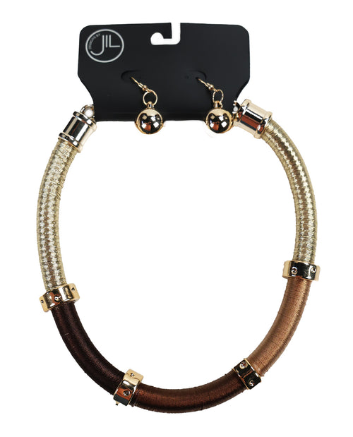 A two-tone braided cord necklace and matching drop earrings on a black display card. The necklace features a textured cream/beige braided cord on the top half and a smooth dark brown braided cord on the bottom half, accented with gold-tone metal caps and beads.