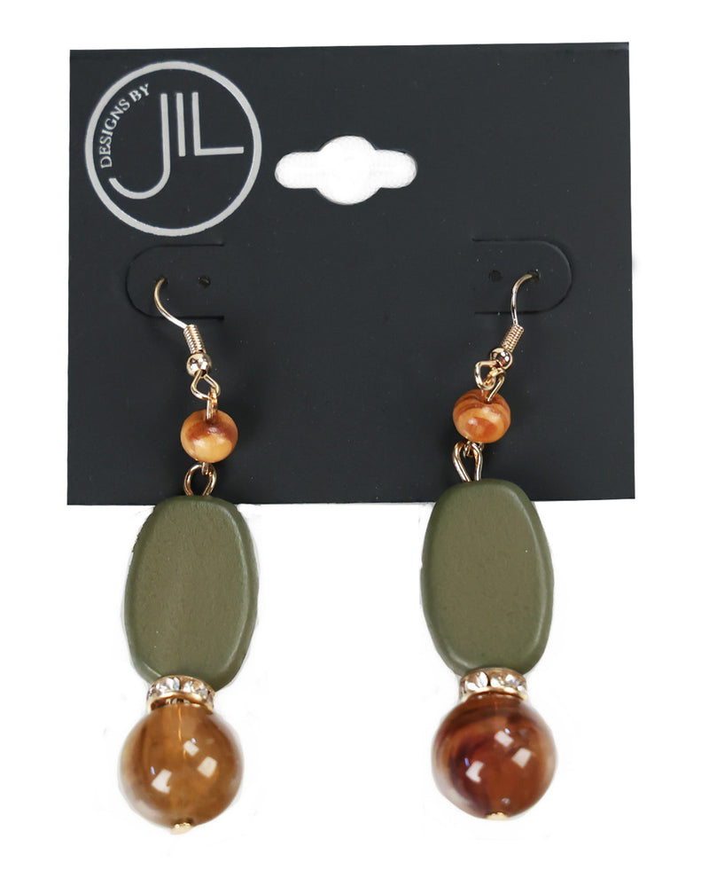 A pair of drop earrings displayed on a black card. Each earring has a gold-tone fishhook, a small round amber bead, a larger olive green oval bead, and a polished brown marbled bead at the bottom separated by a tiny clear rhinestone ring.