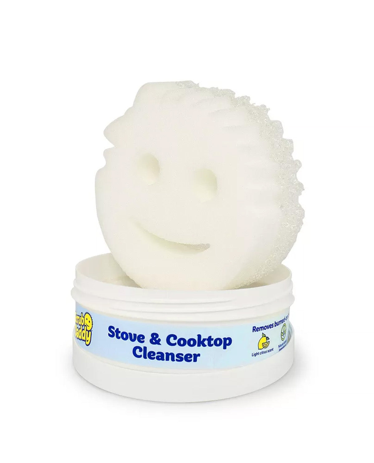 A white textured cleaning sponge with a smiley face cutout, resting on top of a white plastic tub labeled 'Stove & Cooktop Cleanser' by Lemon Scout.