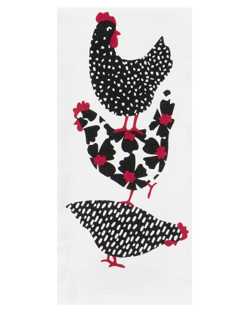 A white kitchen towel featuring a stylized pattern of three black chickens with white spots and red accents, set against a plain white background.