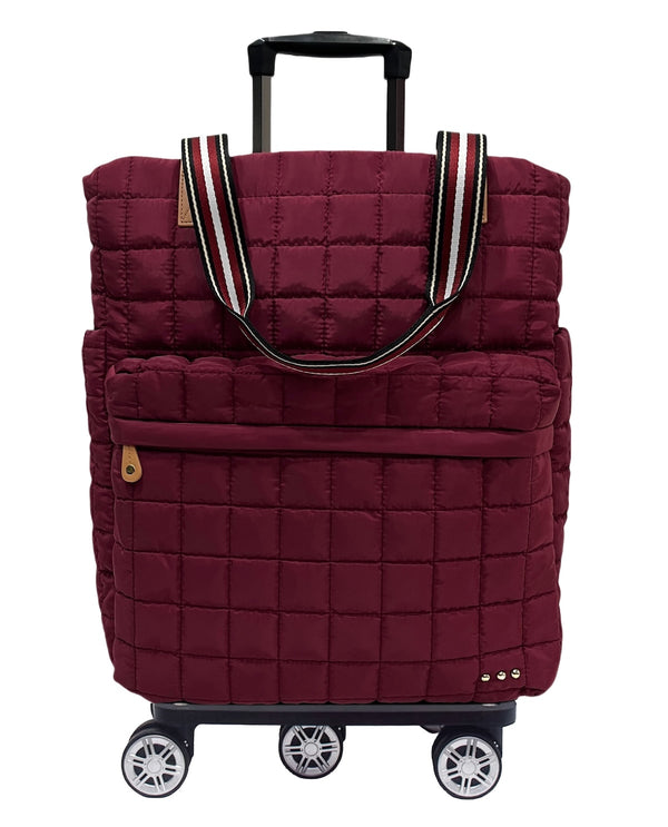 A burgundy quilted rolling tote bag with an extended black telescoping handle and four spinner wheels, shown on a plain white background.