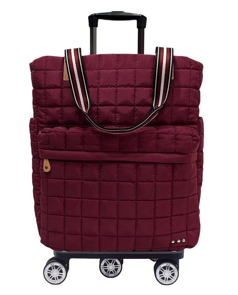 A burgundy quilted rolling tote bag with an extended black telescoping handle and four spinner wheels, shown on a plain white background.