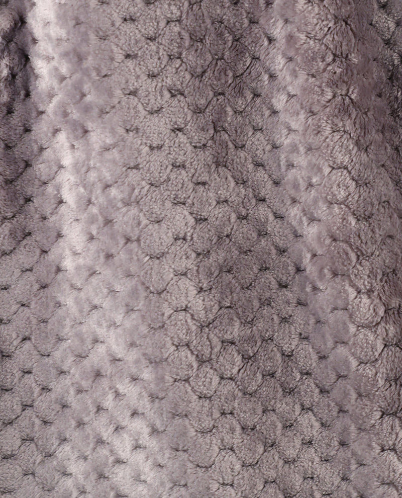 Close-up of a textured plush fabric with a raised honeycomb or bubble pattern in a soft taupe-gray color.