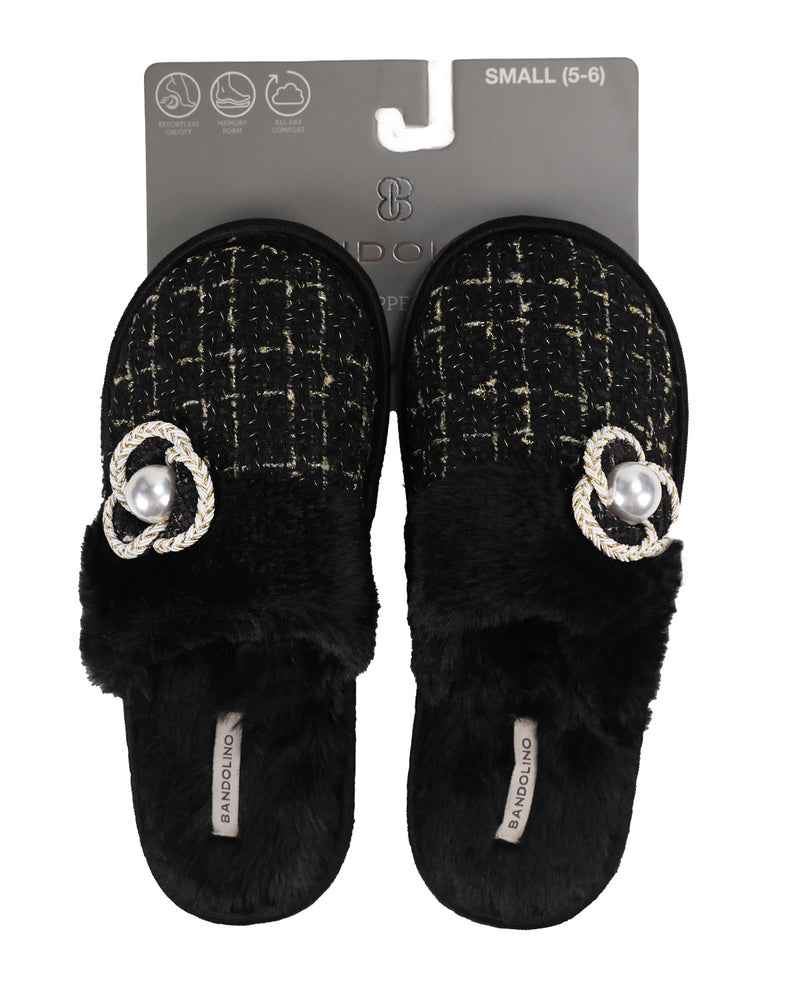 A pair of black slippers with a black and gold tweed pattern, plush black faux fur trim, and a decorative silver-tone double-ring charm with a pearl center, shown on their gray retail backing card.