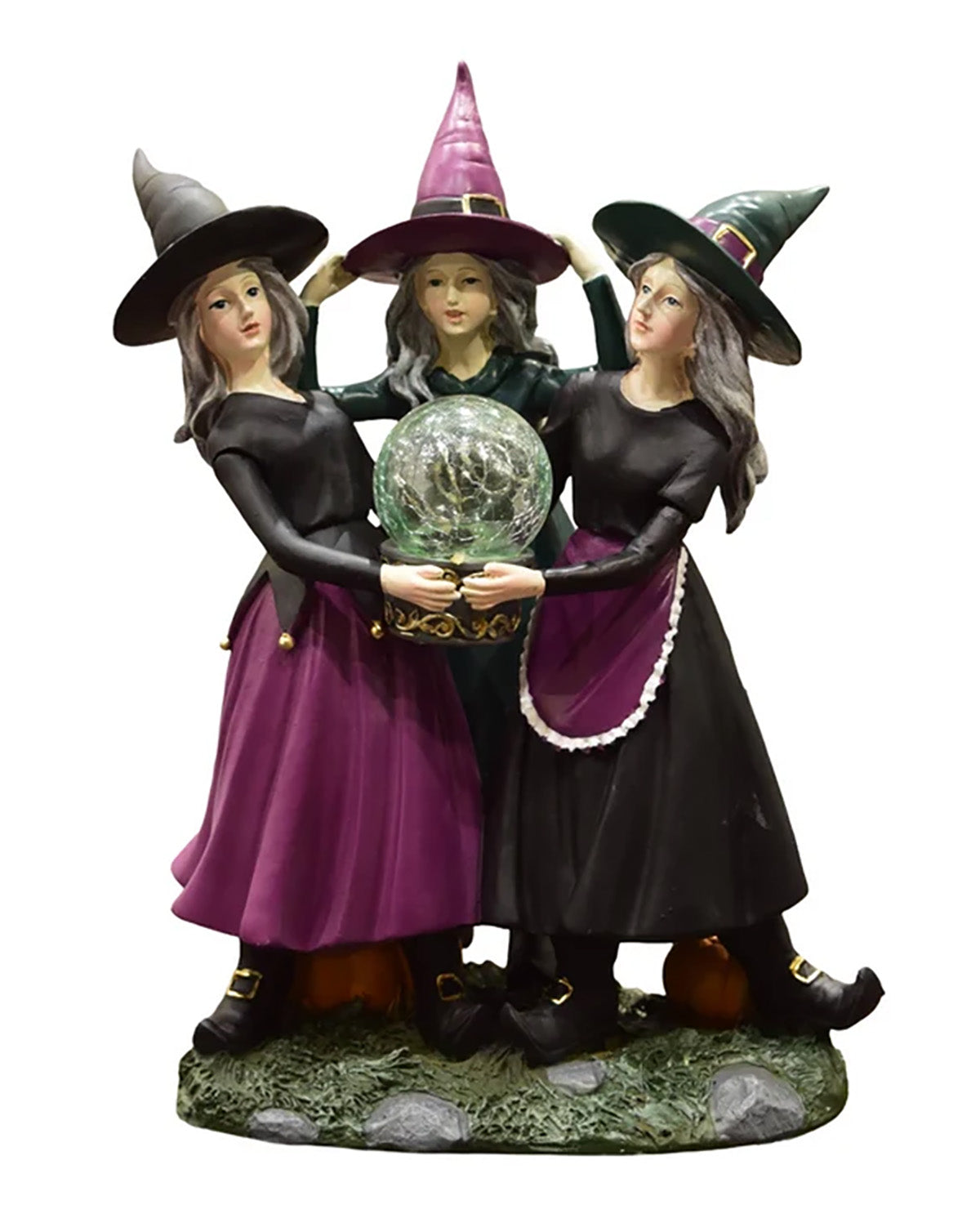 Three witch figurines standing together on a decorative base, each wearing a pointed hat and long dark dress, holding a glowing crystal ball. The scene is isolated on a plain white background.