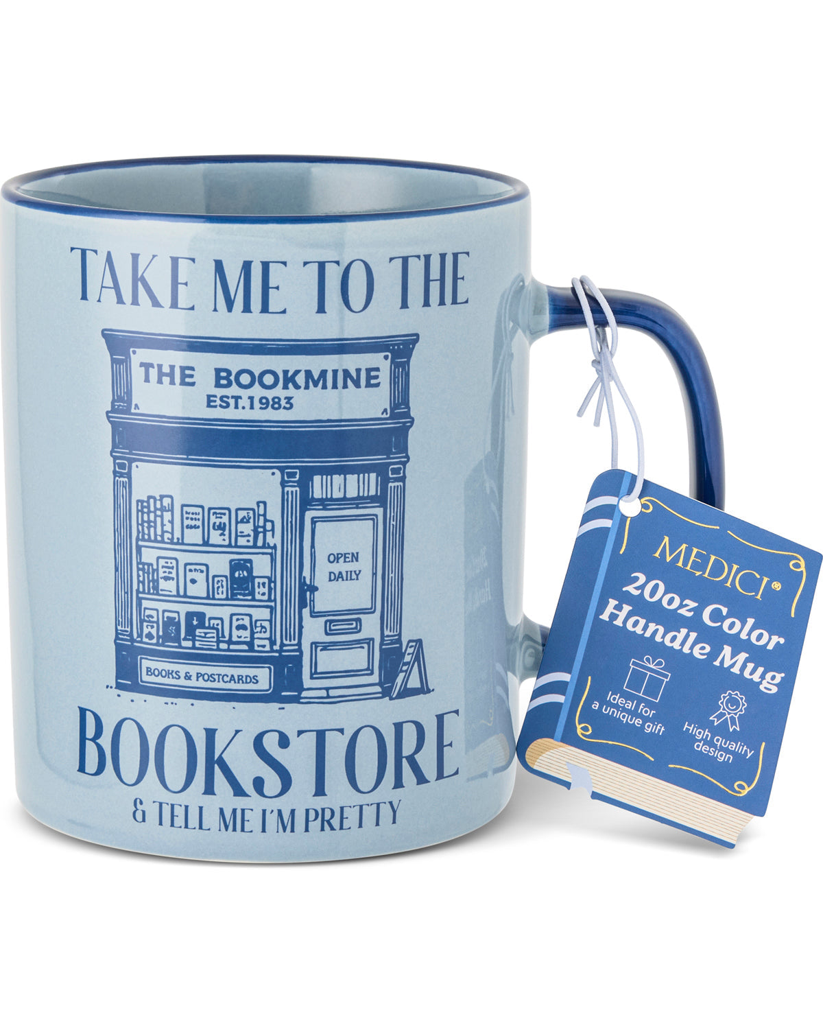 A light blue ceramic mug with a dark blue handle and rim, featuring a navy blue illustration of a bookstore and the text 'TAKE ME TO THE BOOKMINE & TELL ME I'M PRETTY'. A blue hangtag for a 'Medici 20oz Color Handle Mug' is attached to the side.