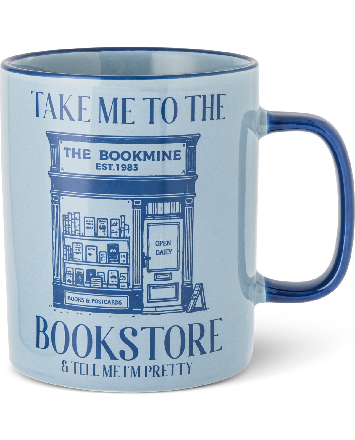 A light blue ceramic mug with a dark blue handle and rim, featuring a blue graphic of a vintage bookshop storefront with the text 'TAKE ME TO THE BOOKMINE' and 'BOOKSTORE & TELL ME I'M PRETTY'.