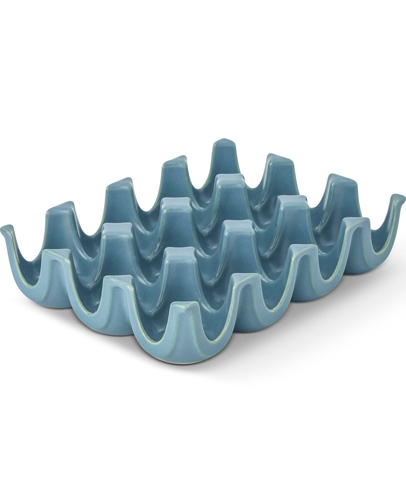 A light blue ceramic egg carton dish with a glossy finish, photographed on a clean white background.