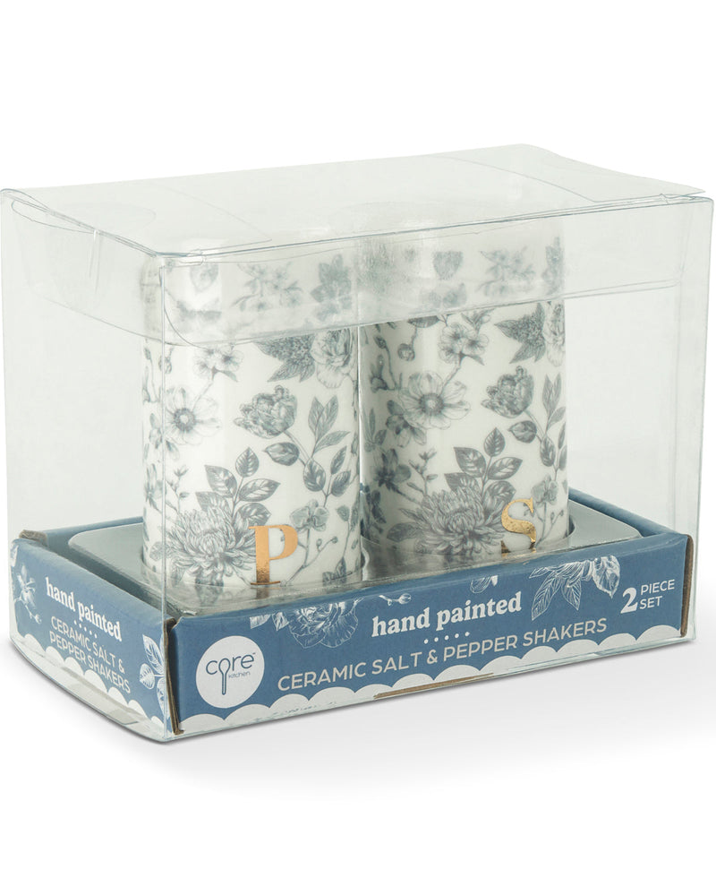 A 2-piece set of hand-painted ceramic salt and pepper shakers in a clear plastic display box with a blue and white base. The shakers feature a delicate blue-gray floral pattern on a white background, with one shaker showing a gold 'P' letter.