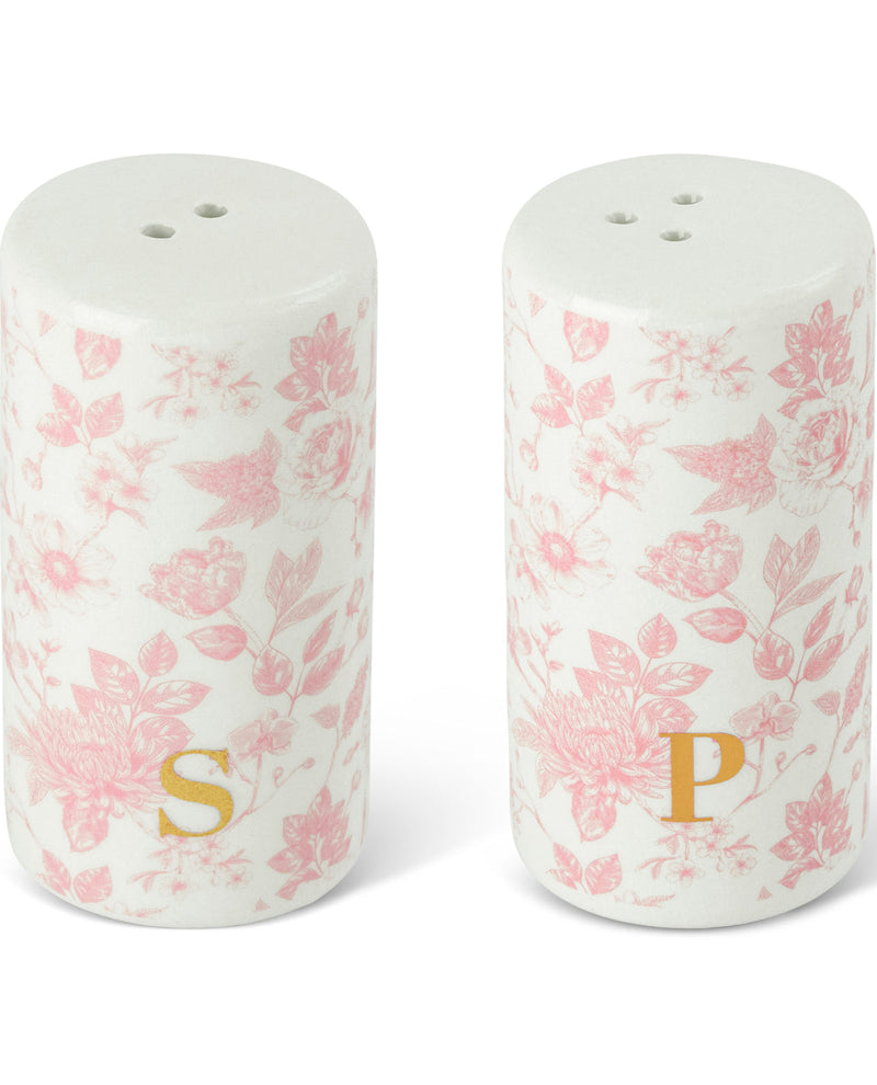 A pair of cylindrical ceramic salt and pepper shakers with a white background and a pink floral toile pattern, featuring gold monogrammed initials 'S' and 'P' at the bottom.