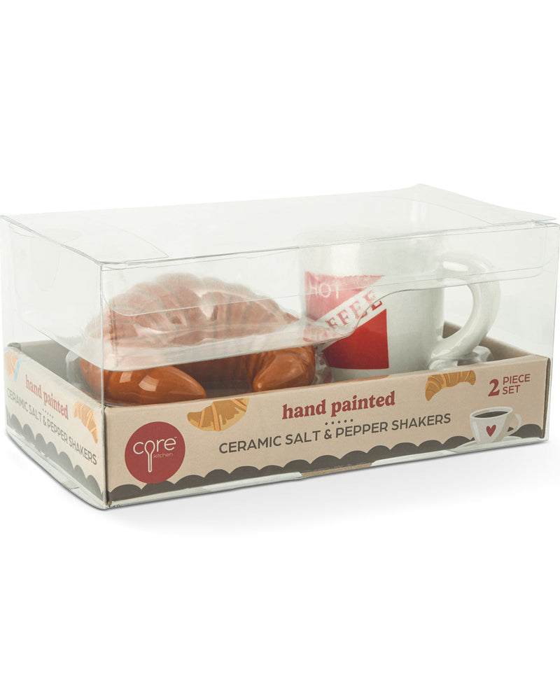 A 2-piece ceramic salt and pepper shaker set by Care For Coffee, packaged in a clear plastic box with a cardboard base. The set includes a white ceramic mug shaker with a red label and a brown ceramic pepper shaker.
