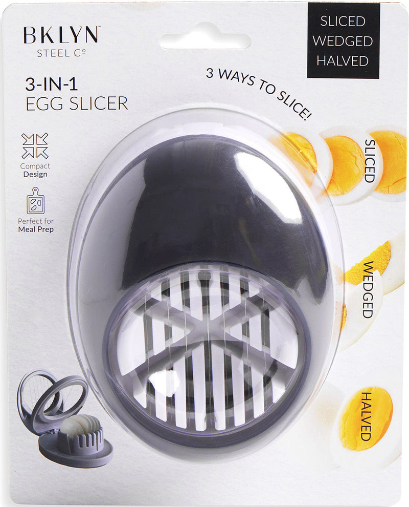 BKlyn Steel 3-in-1 egg slicer in its retail packaging, featuring a dark gray plastic slicer inside a clear oval shell on a white backing card with product details.