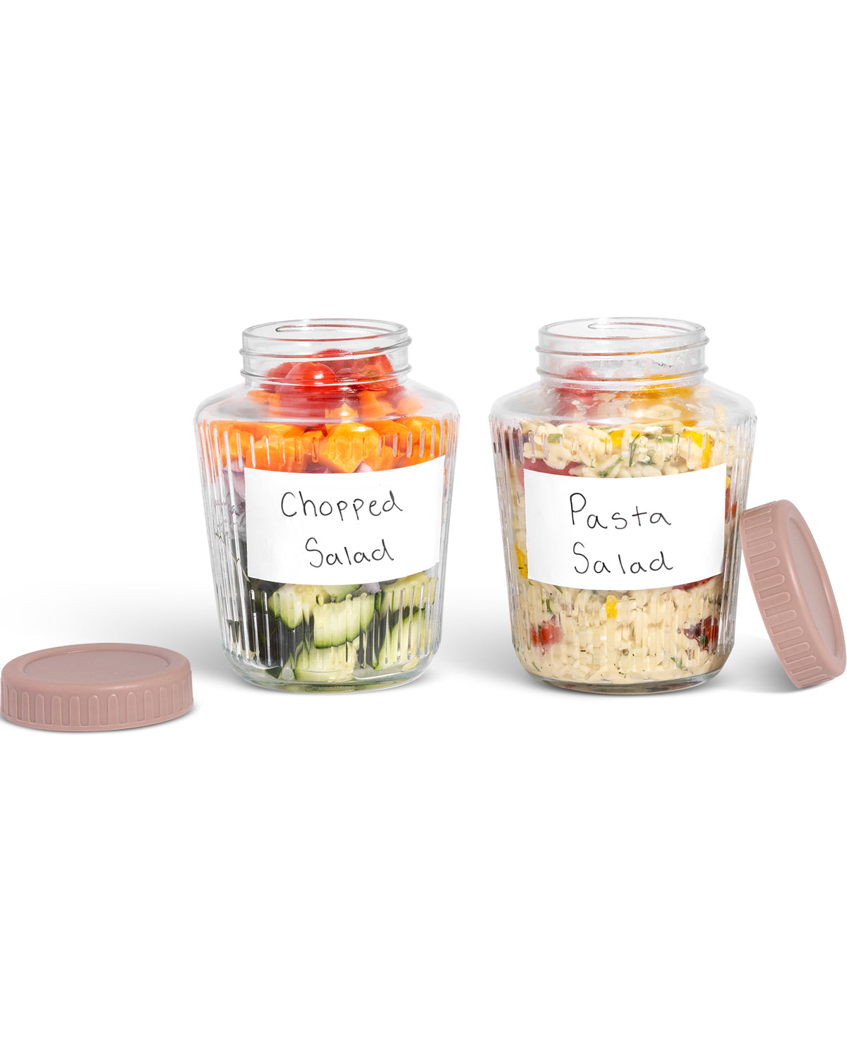 Two clear glass storage jars with screw-top lids, shown on a white background. One jar is labeled 'Chopped Salad' and contains mixed vegetables, and the other is labeled 'Pasta Salad' and contains pasta salad.
