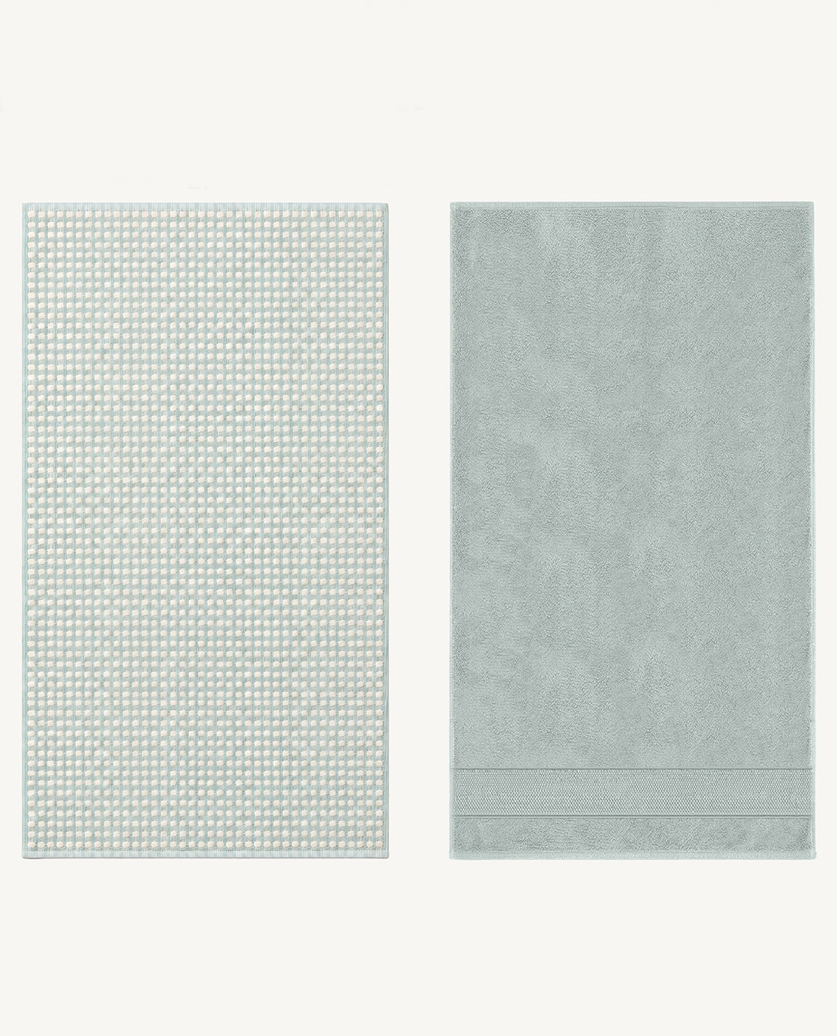 Two rectangular bath towels in a pale icy green color, displayed side by side on a clean off-white background. The towel on the left features a repeating geometric dot pattern, while the towel on the right has a subtle damask texture and a decorative border at the bottom.