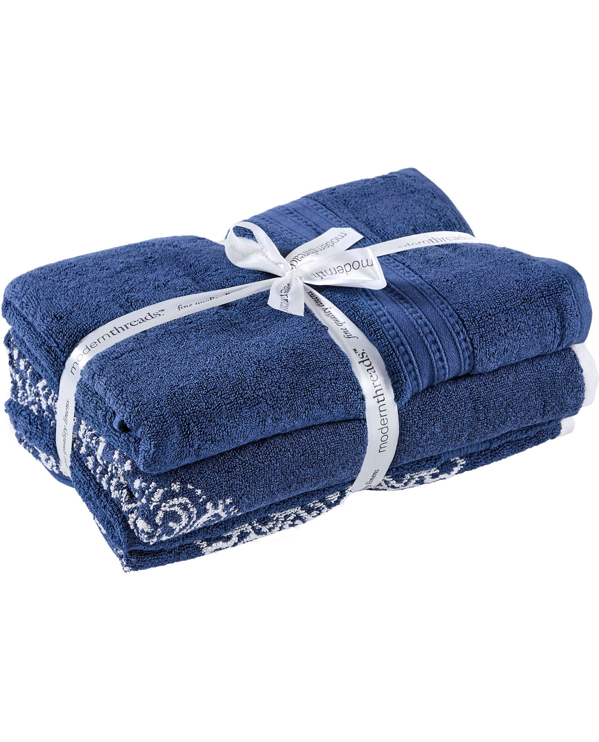 A set of folded dark blue towels with white embroidered lace trim, wrapped in a white ribbon printed with the brand name 'modernthreads'.