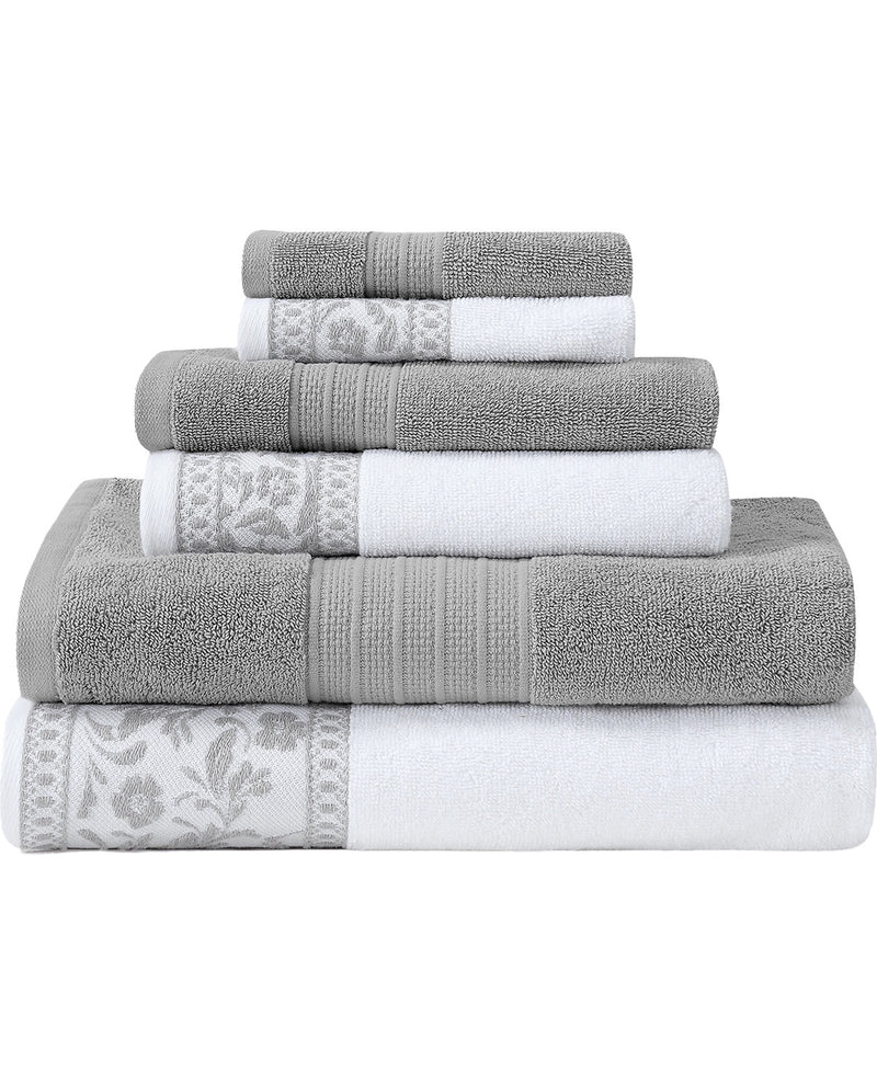 A stack of five folded towels in gray and white, including hand towels, washcloths, and bath towels, arranged by size on a plain white background.