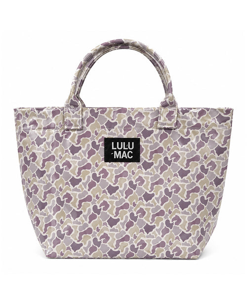 A Lulu Mac tote bag featuring a purple, beige, and gray camouflage pattern, with a black brand label on the front and dual top handles, set against a plain white background.