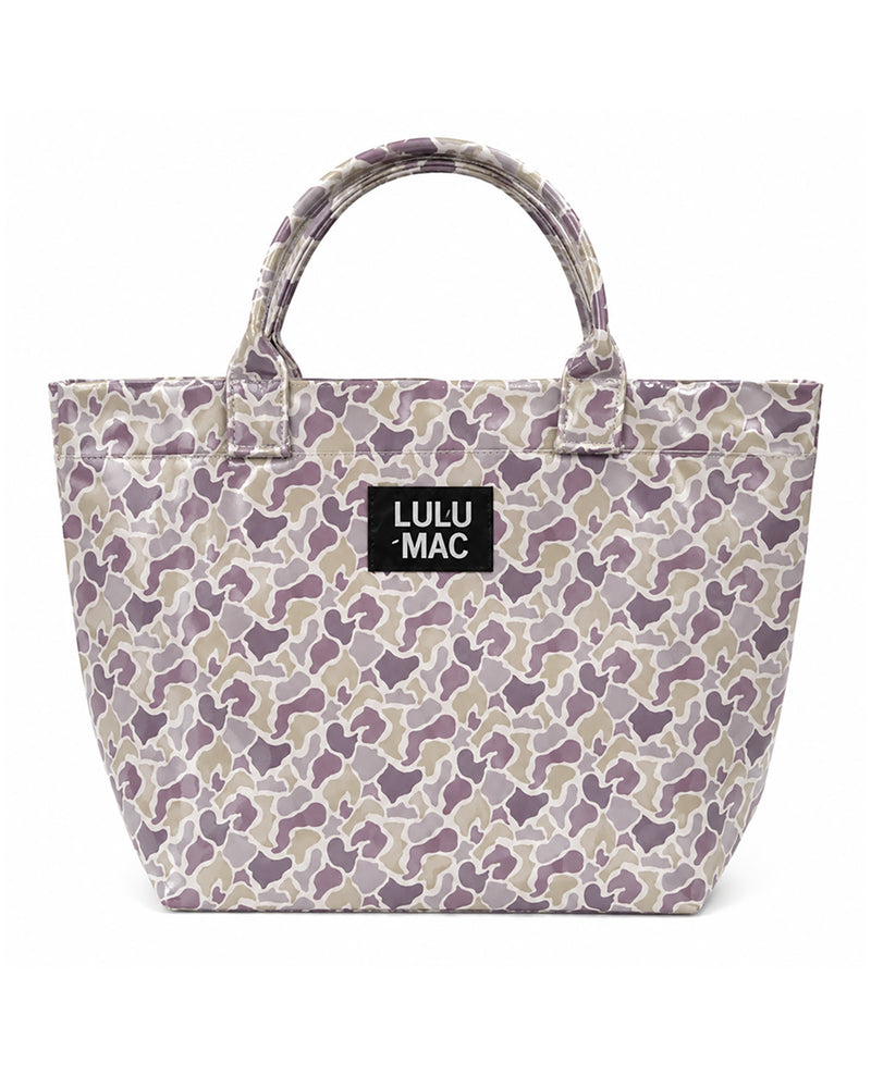 A Lulu Mac tote bag featuring a purple, beige, and gray camouflage pattern, with a black brand label on the front and dual top handles, set against a plain white background.