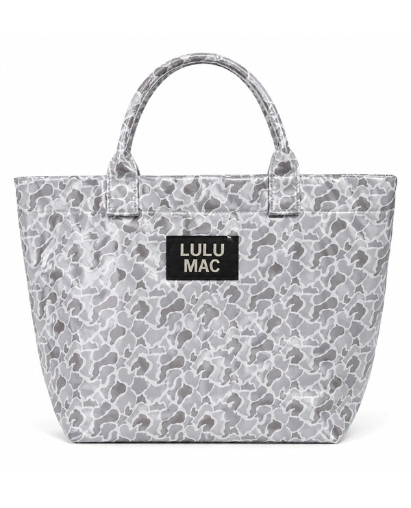 A gray and white camouflage tote bag with a black rectangular patch on the front that reads 'LULU MAC' in white text, set against a plain white background.