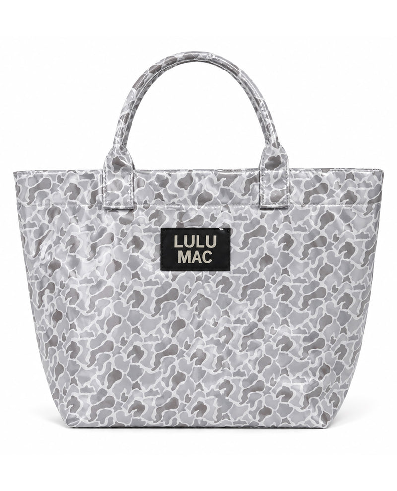 A gray and white camouflage tote bag with a black rectangular patch on the front that reads 'LULU MAC' in white text, set against a plain white background.