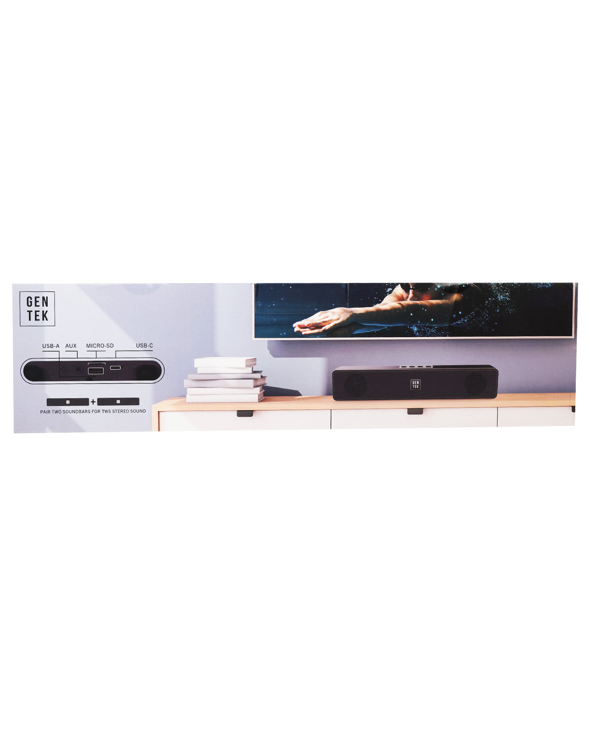 A wide product shot showing a GenTek soundbar setup in a modern room scene. The black soundbar sits on a light wood console below a TV displaying a dancer, with a matching black rectangular device on the console.