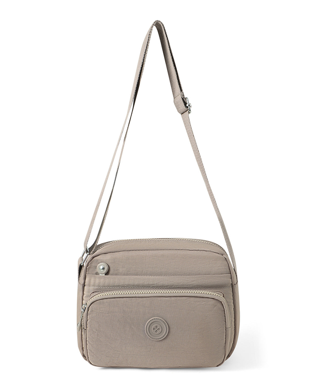 A taupe crossbody bag with a single shoulder strap, featuring a zippered front pocket and a circular metal logo emblem on the front, set against a plain white background.