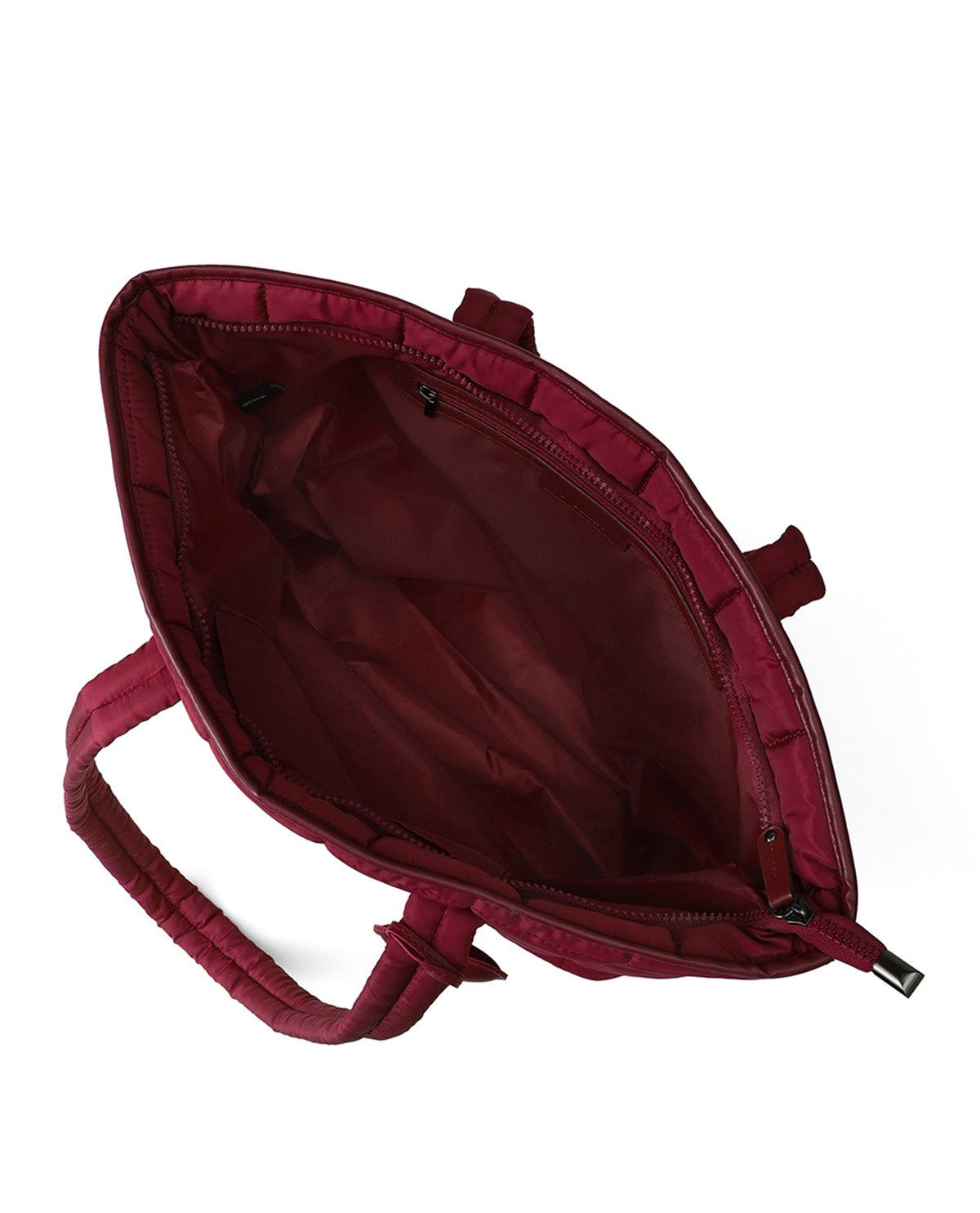 An open burgundy tote bag shown from a top-down angle, displaying its spacious interior, padded handles, and zipper closure against a plain white background.
