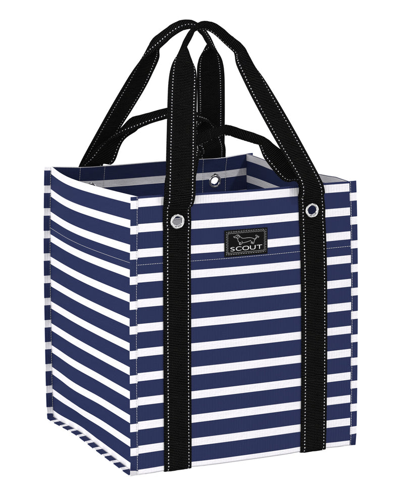 A Scout brand tote bag with navy blue and white horizontal stripes, featuring black webbed handles with white stitching and a black brand label on the front.