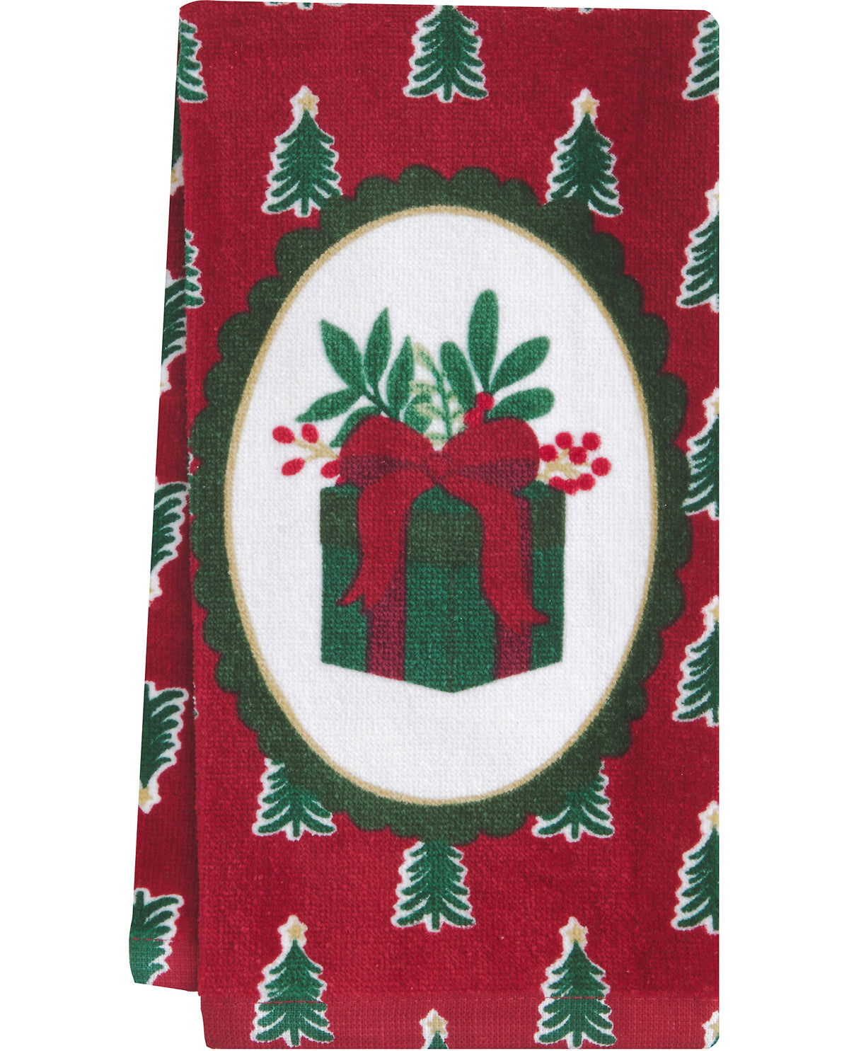 A red holiday-themed fabric napkin or tea towel featuring a central white oval with a green gift box, red bow, green leaves, and red berries, surrounded by a green scalloped border and small green Christmas trees on a red background.