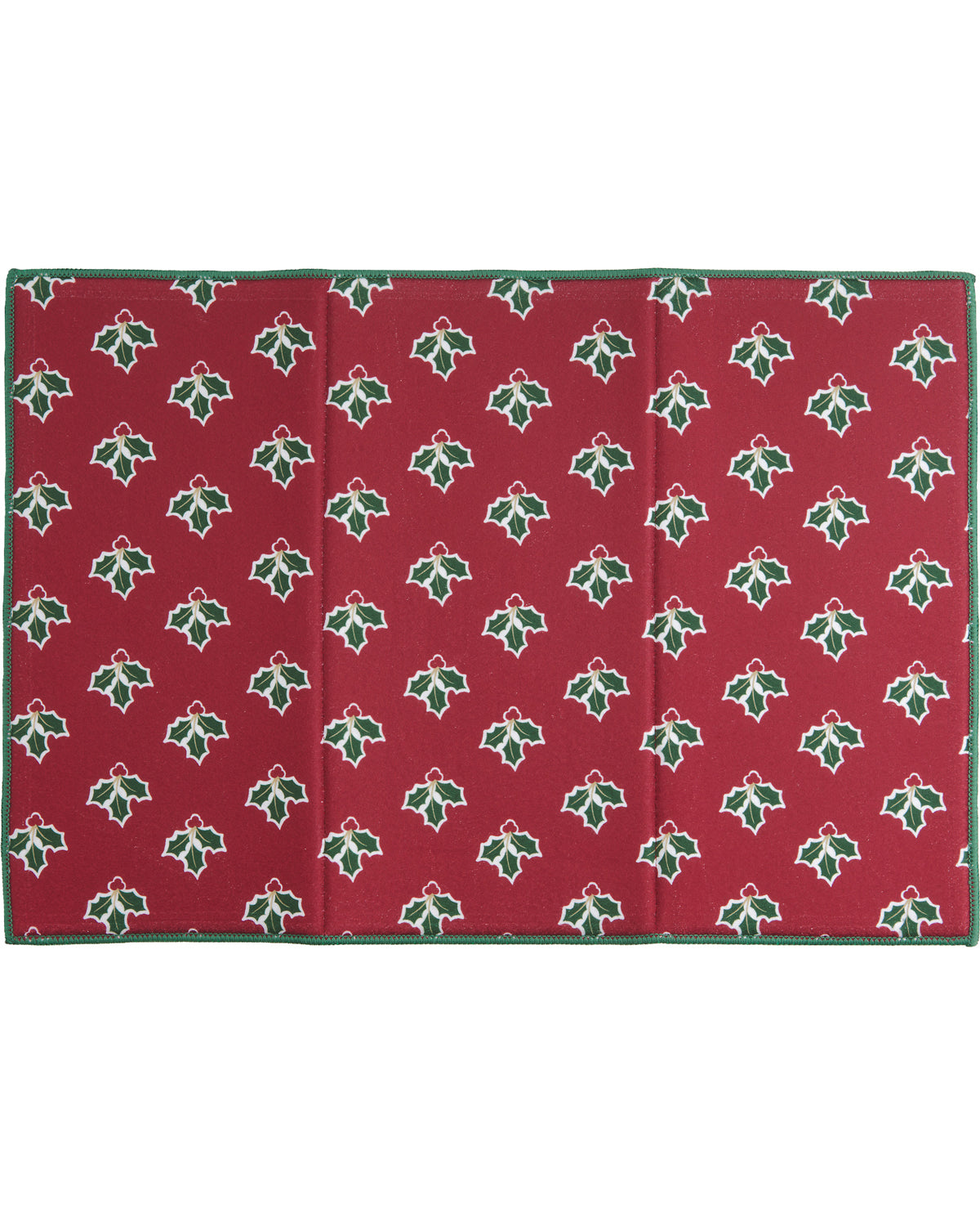 A rectangular red fabric item, likely a blanket or mat, featuring a repeating green holly leaf and red bow pattern with a solid green border, shown flat against a white background.