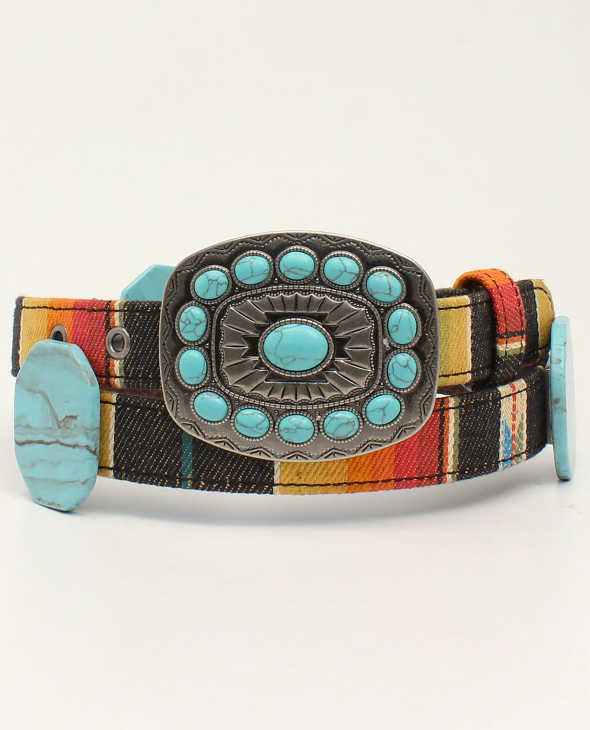 A western-style belt featuring a colorful striped fabric strap with black, red, yellow, and orange tones, a large engraved silver-tone buckle adorned with turquoise stones, and a matching turquoise stone on the keeper.