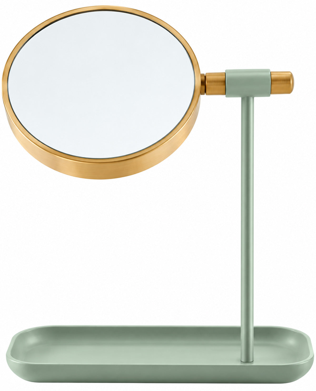 A desktop vanity mirror with a round reflective glass face, a brushed gold metal frame, a pale sage green stand, and a matching sage green tray base, shown on a plain white background.