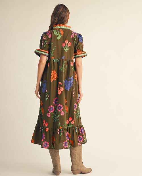 Woman wearing a floral dress with a plain background