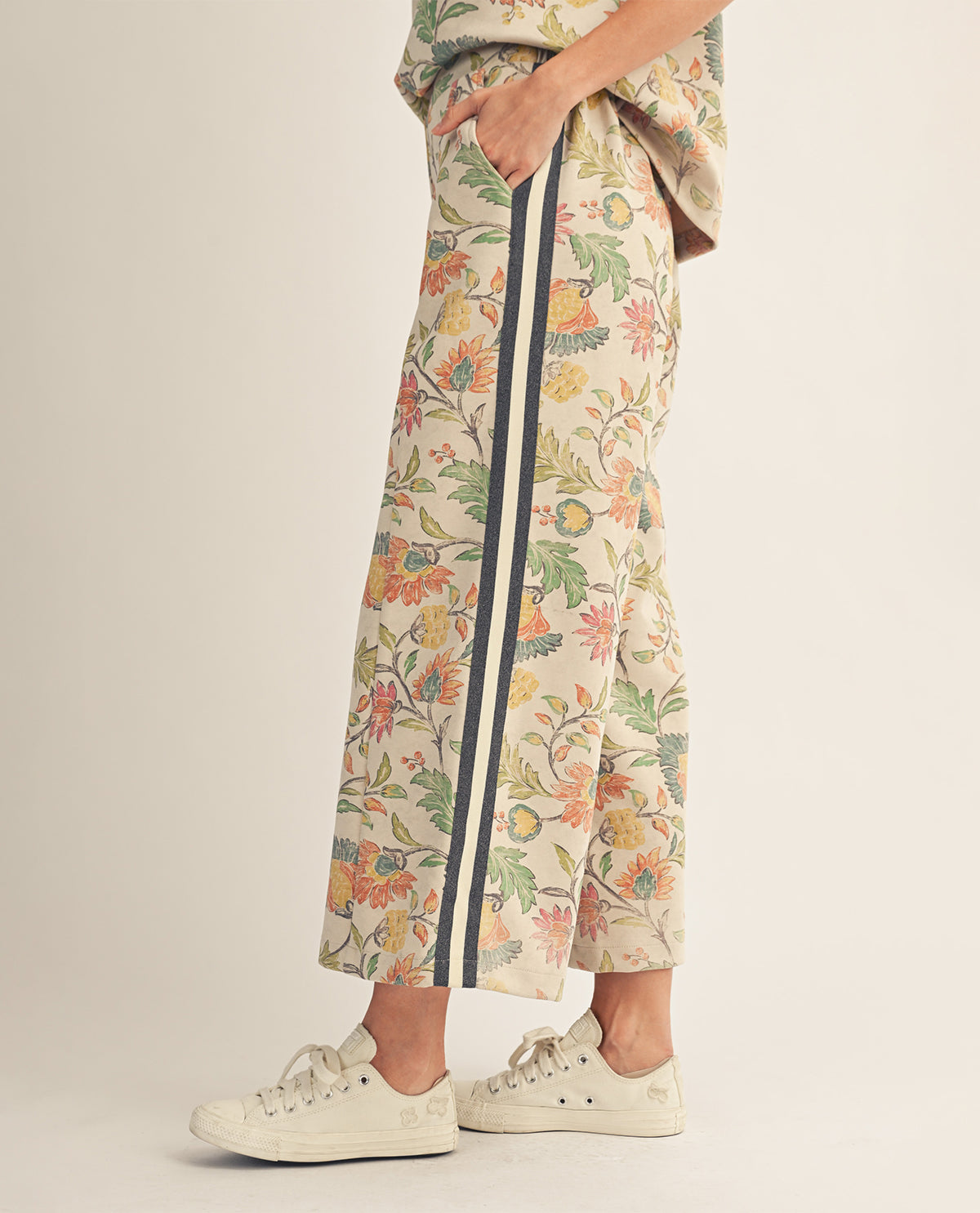 Floral-patterned pants with a stripe on a plain background