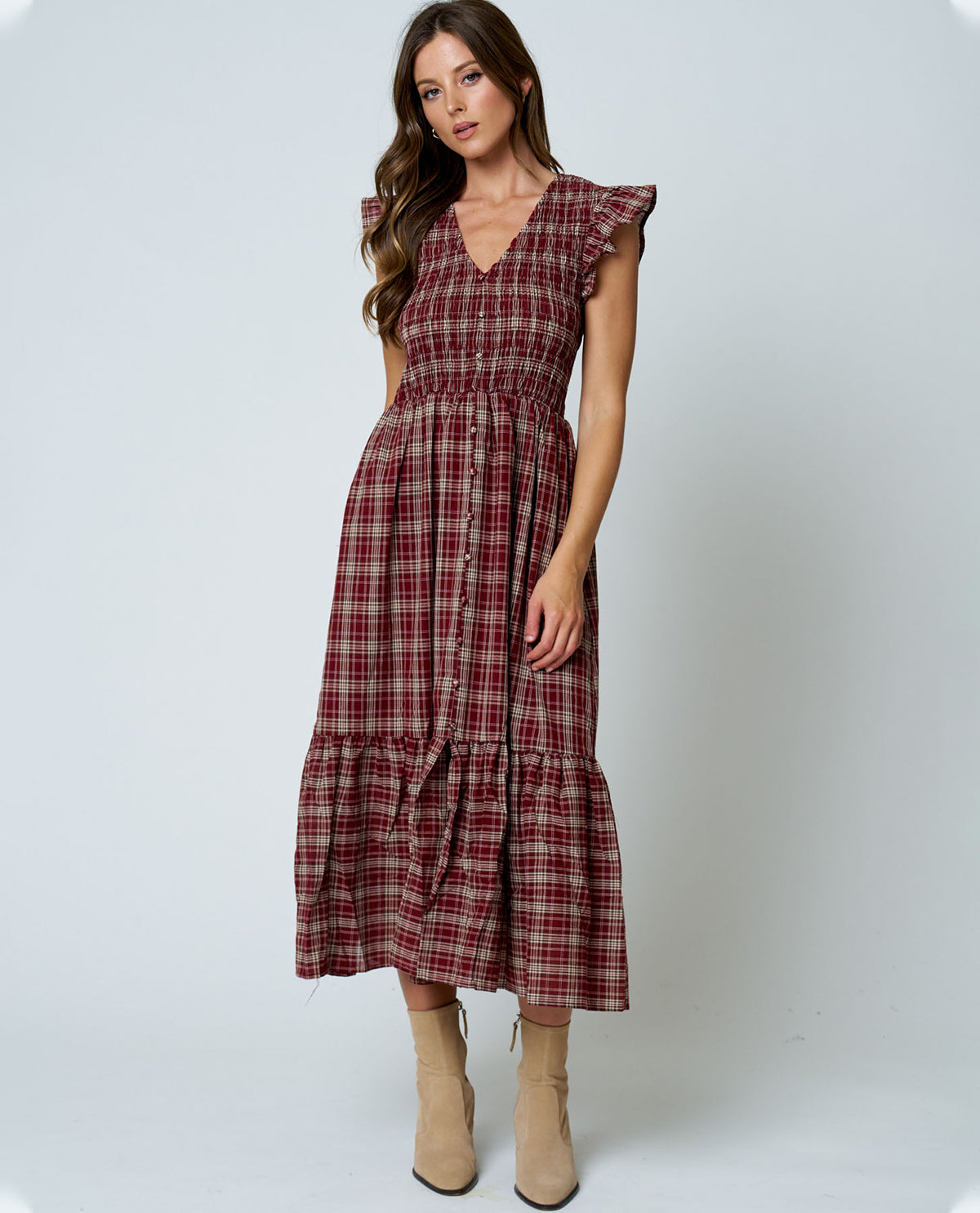 Woman wearing a plaid dress on a white background