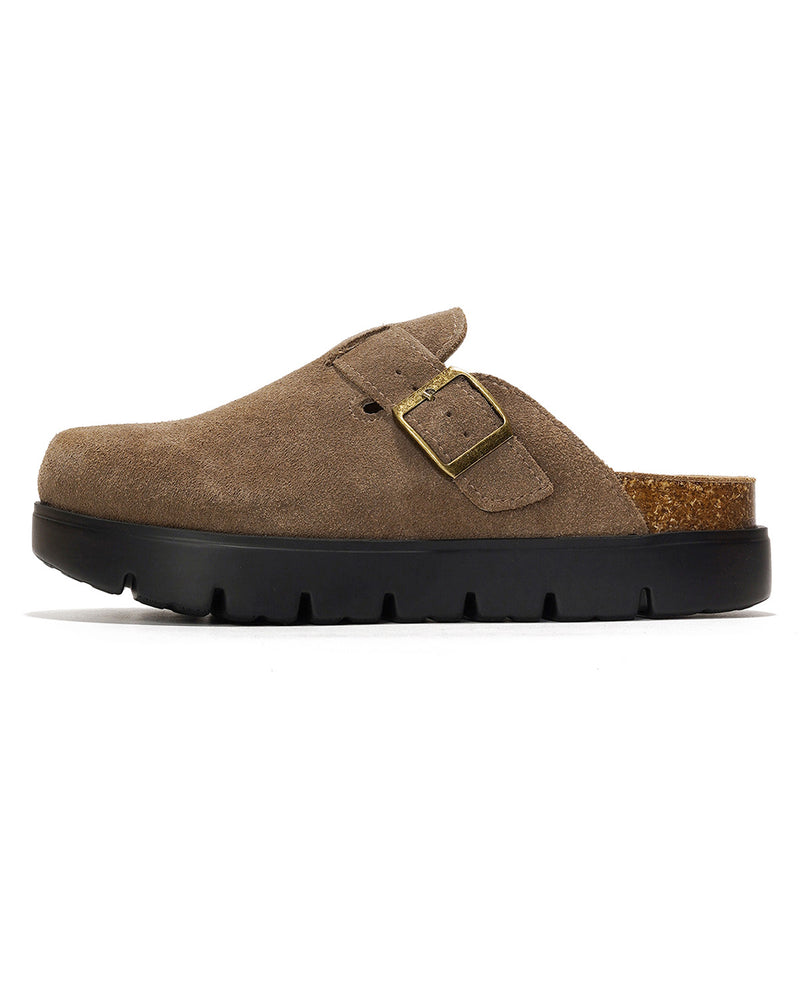 A single brown suede clog shoe with a black sole and a gold buckle strap, shown in profile against a white background.