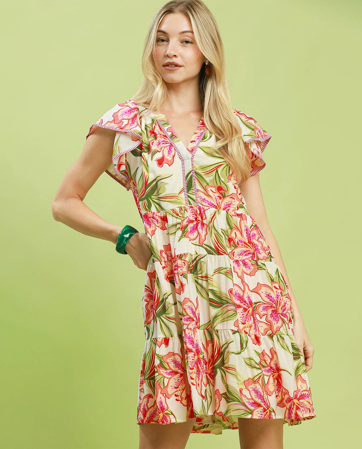 Woman wearing a floral dress on a green background