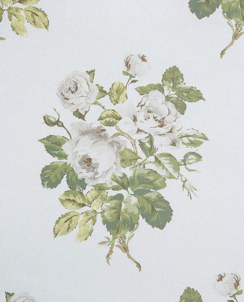 A close-up of a floral print featuring white roses with green leaves on a very light off-white background.